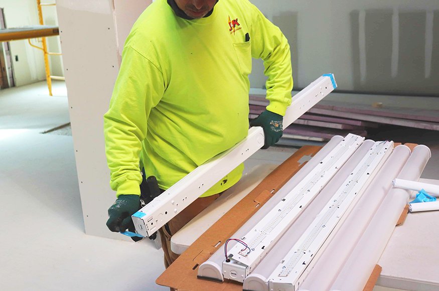 Second-floor lighting installation underway.