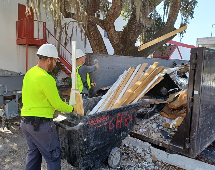 Crew members take out the debris
