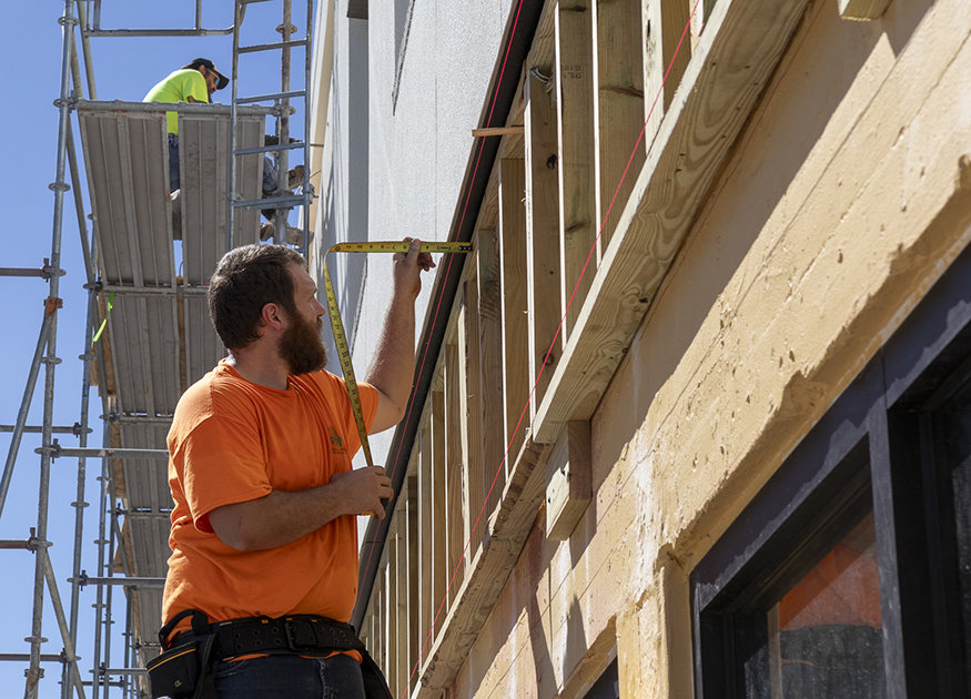 A measuring tape is used to ensure proper alignment.