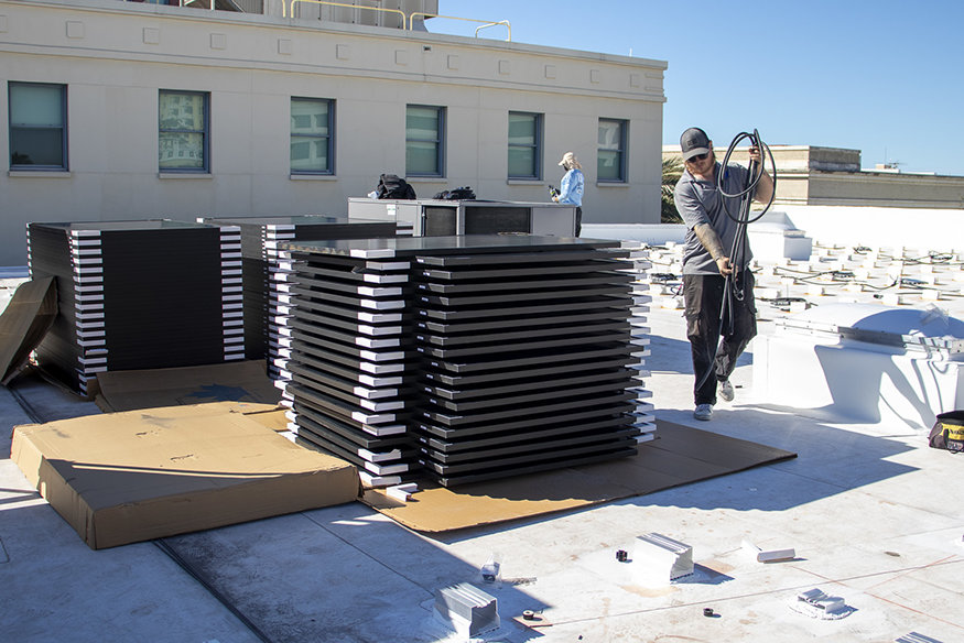 Crews unpack and stage panels ahead of installation.