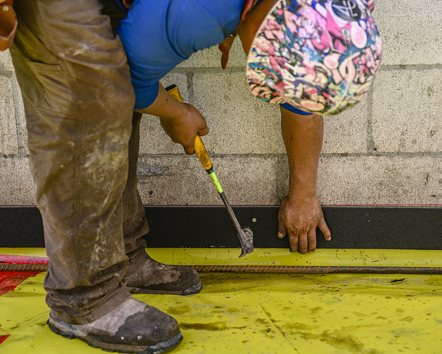 Expansion joint material installed along wall edge.