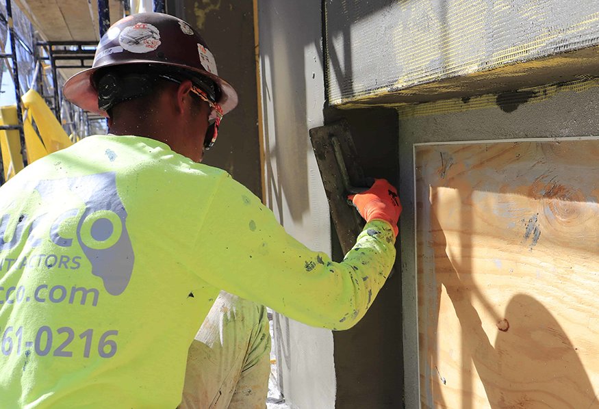 Applying stucco-like base coat.