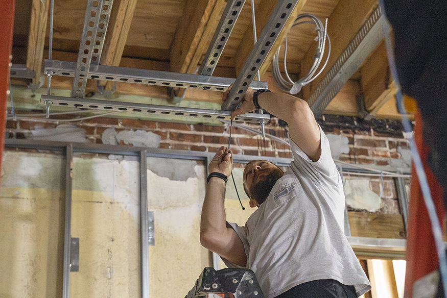 A level is used to ensure alignment before framing is secured.