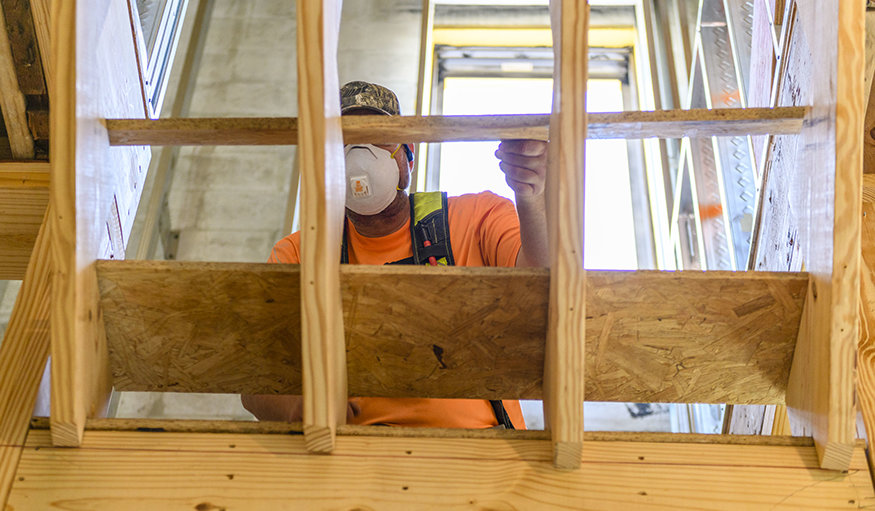 Crew lay down the stair tread.