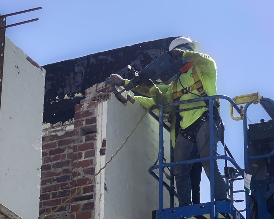 Crew members taking off a parapet piece