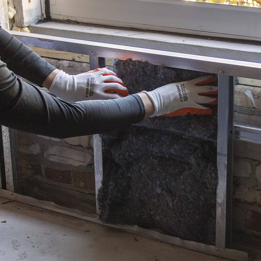 Blue insulation between framing studs.
