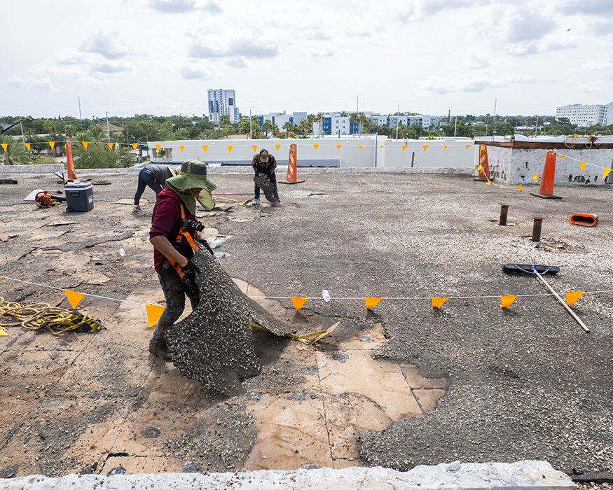 Workers remove roofing materials on 639 Cleveland Street.