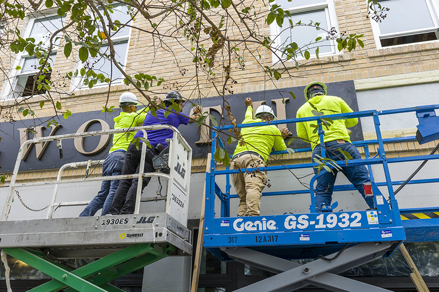 Crews lifting the Woolworth letters.