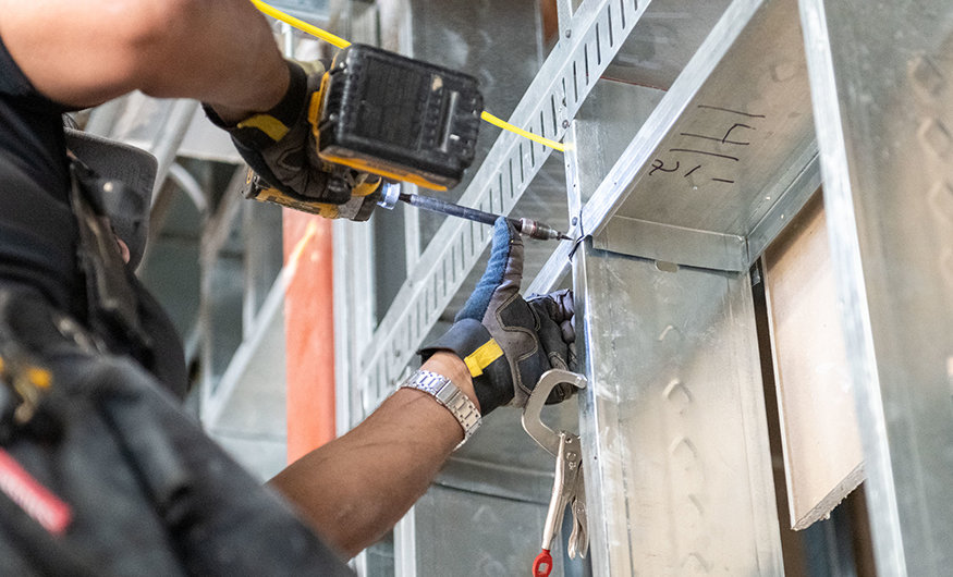 Drill securing steel framing connection.