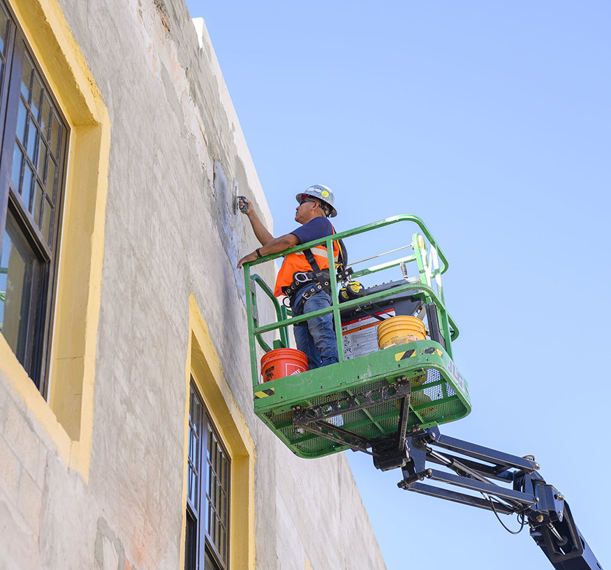 Worker applying parge coat.