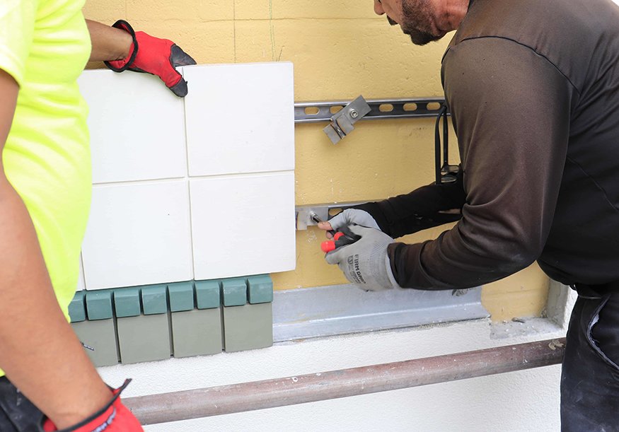 Mounting bracket system is installed ahead of tile.