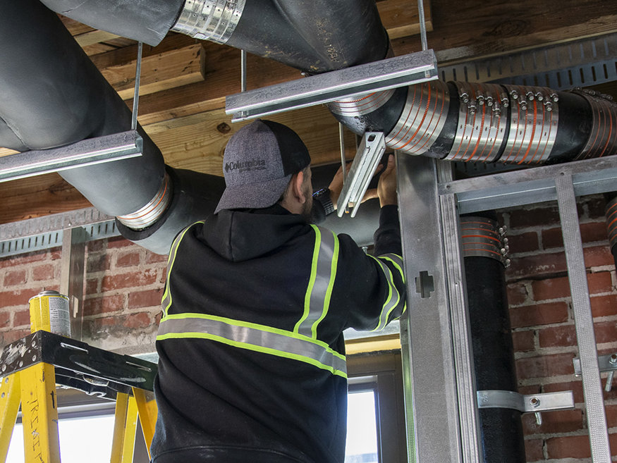 Securing insulation around pipes.