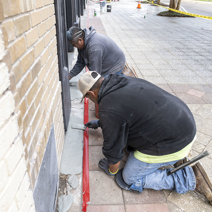 Concrete is shaped to create a clean transition into the storefront.