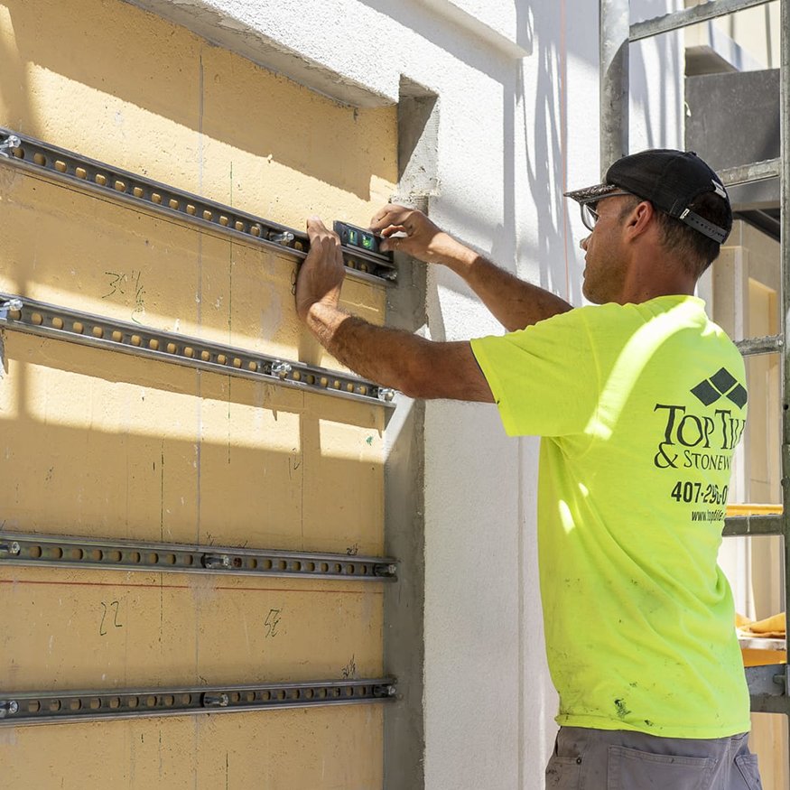 Close view of metal rails mounted on exterior wall.