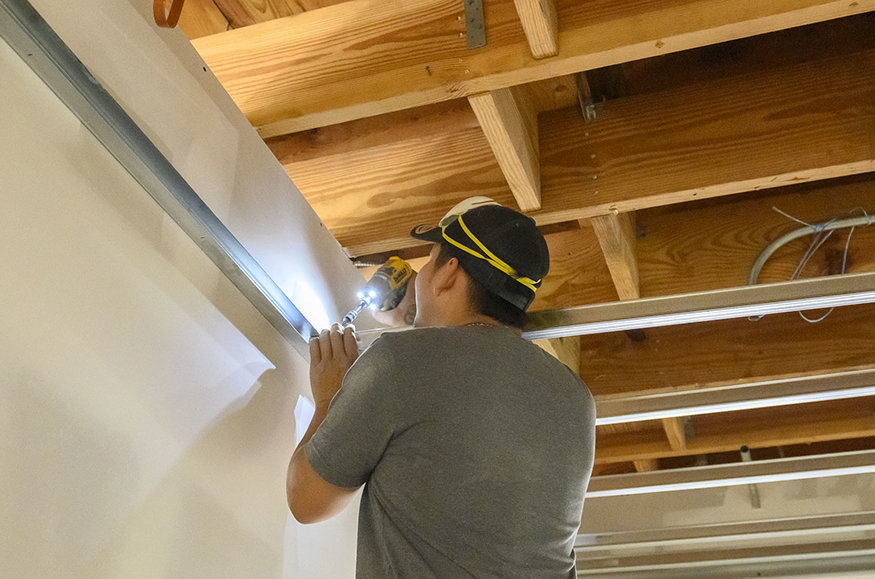 Securing ceiling framing on second floor.