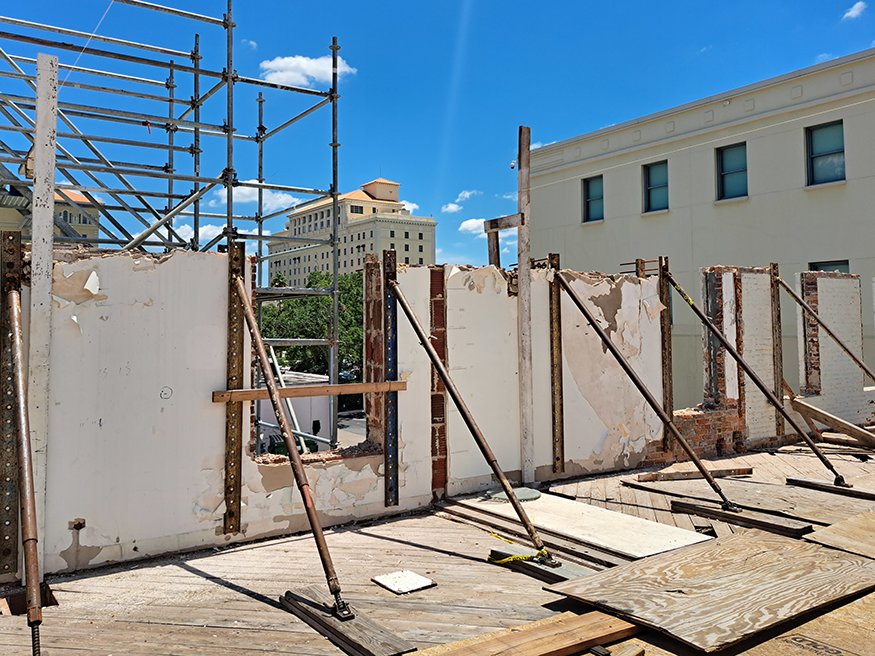 Exposed brick and block layers during Woolworth wall demolition process.
