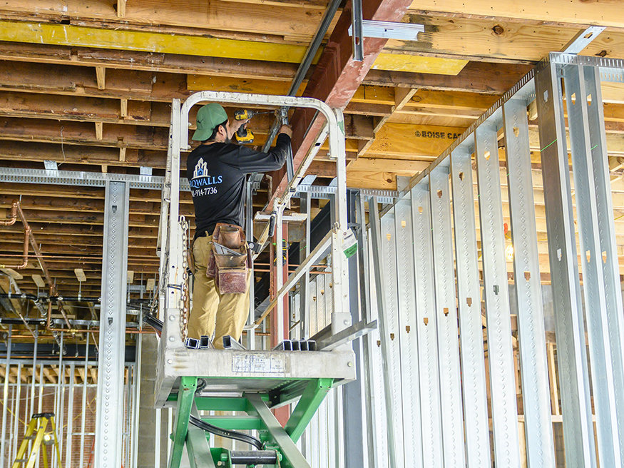 Metal wall framing is set for electrical conduit at Peoples Bank.