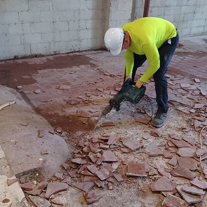 Cleared floor area post-demolition with no remaining tile.