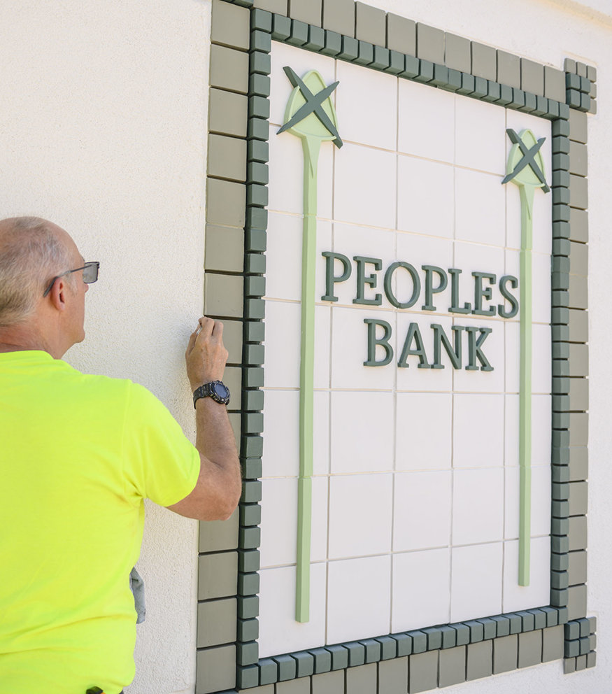 Detail painting along Peoples Bank tile border.