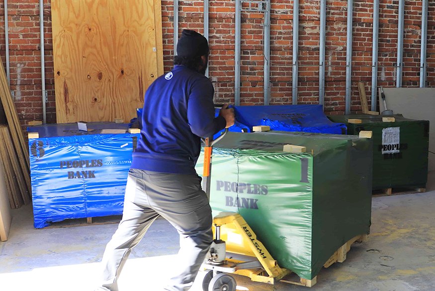Oversized Mediterranean mosaic tiles, notable for their weight and scale, arrive at the Peoples Bank building.